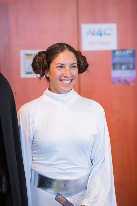 a woman dressed in white poses for the camera