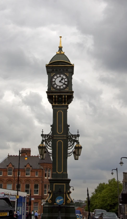 a large clock is sitting outside under a cloudy sky