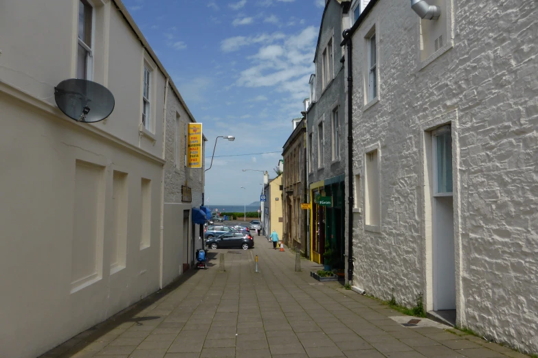 a small sidewalk between two buildings on both sides