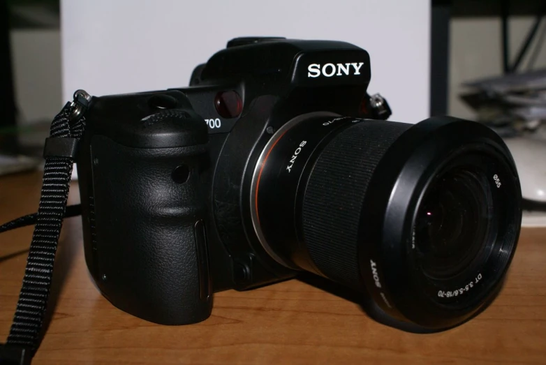 a black camera sitting on top of a wooden table