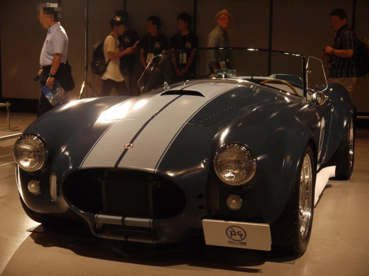 a vintage sports car on display at an automobile museum