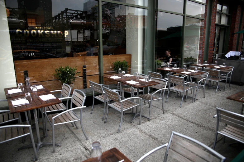 a restaurant with tables and chairs lined up against glass