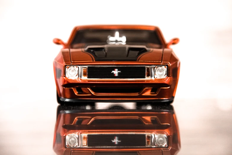 a toy model of a muscle car with hood and headlights