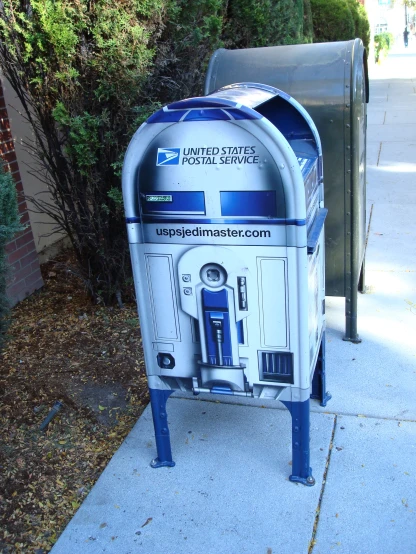 a star wars trash can that is sitting on the sidewalk