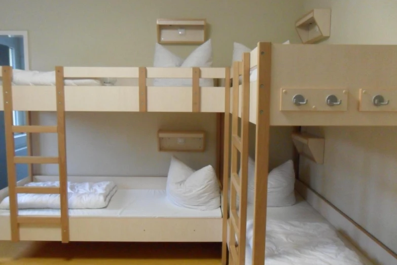 a bedroom with bunk beds and towels under the sheets