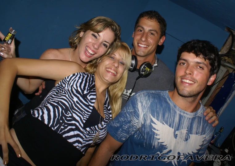 group of friends hanging out at nightclub in front of large speakers