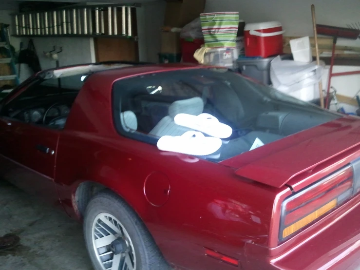 a red car is parked in a garage