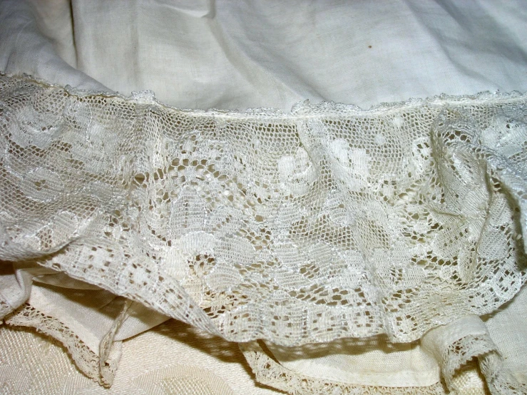 an embroidered white cloth with small floral designs
