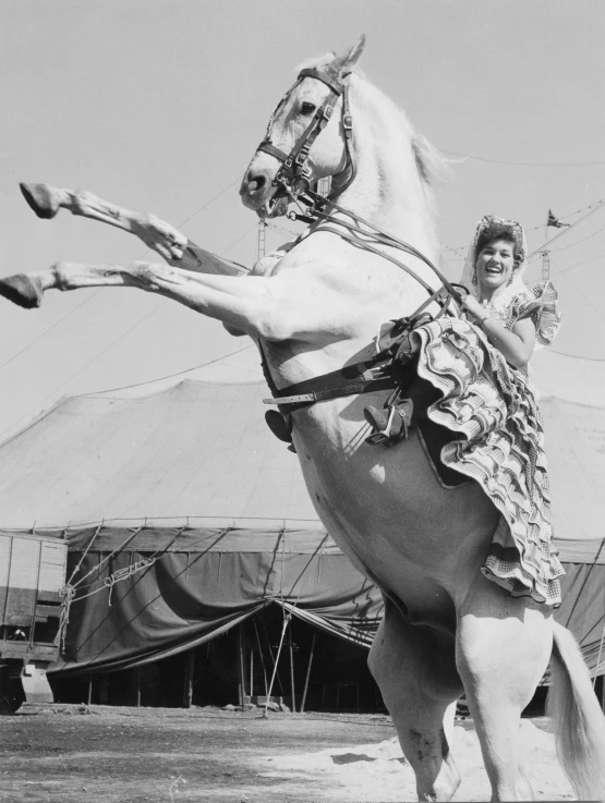 a girl that is riding on a horse