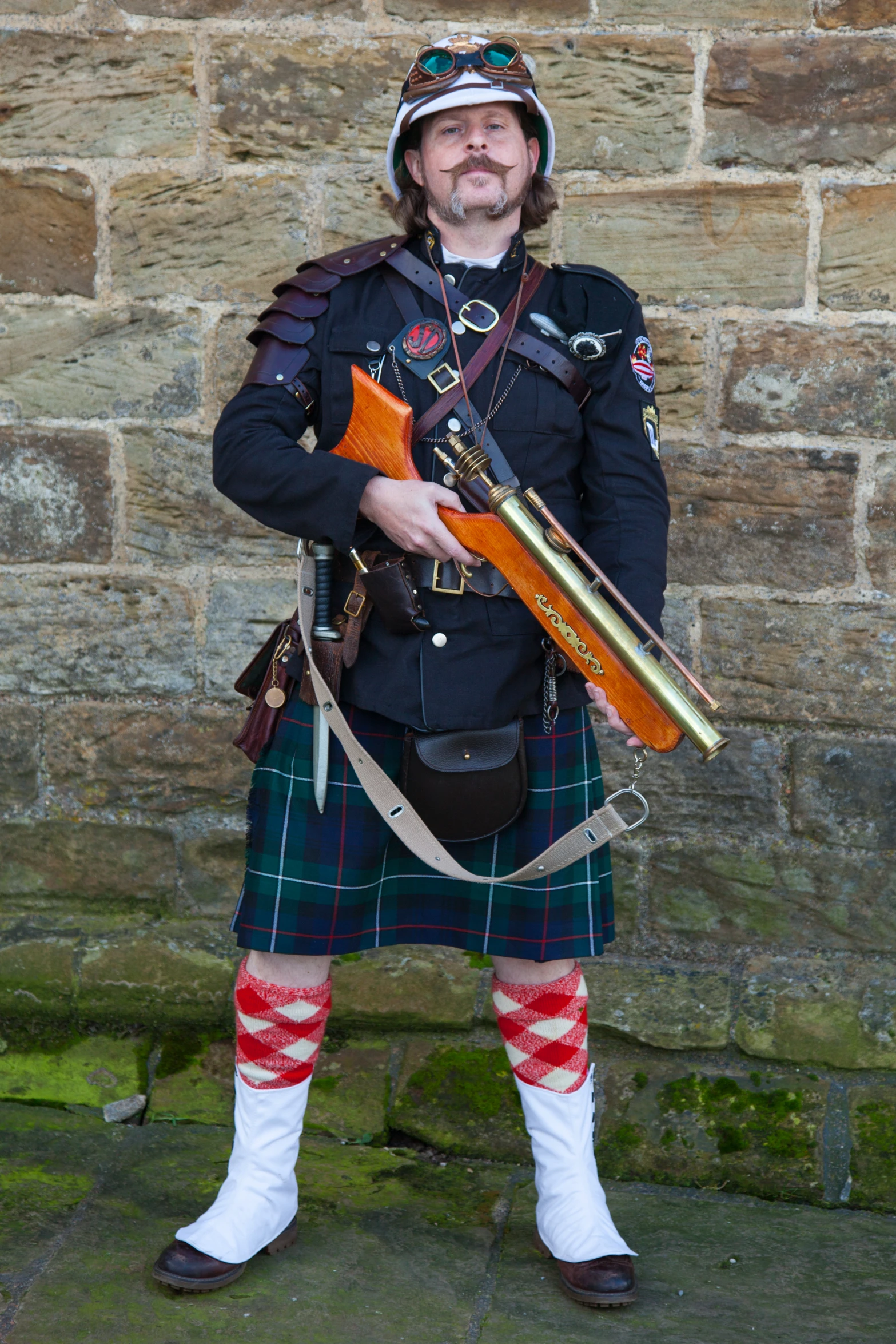 a man dressed in a kilt with a rifle