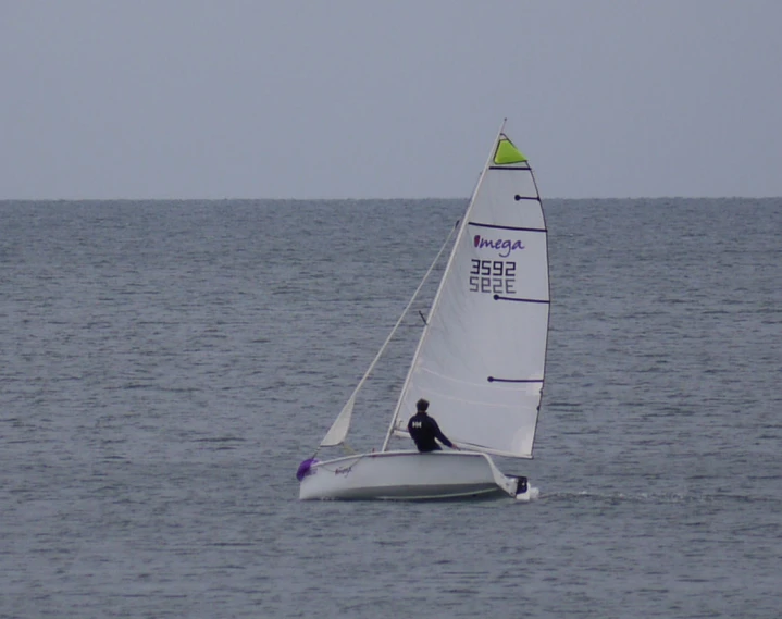 a person on a small sail boat on the water