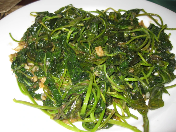 a white plate topped with green vegetables