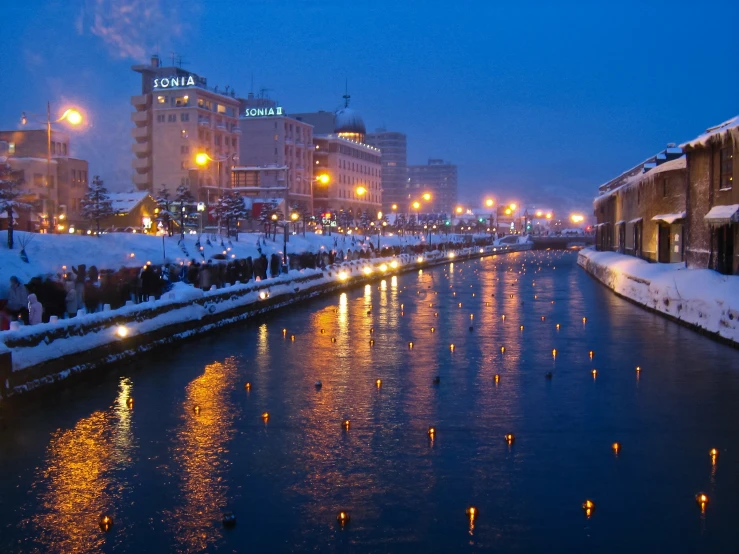 a city street is lit up by many lights during winter