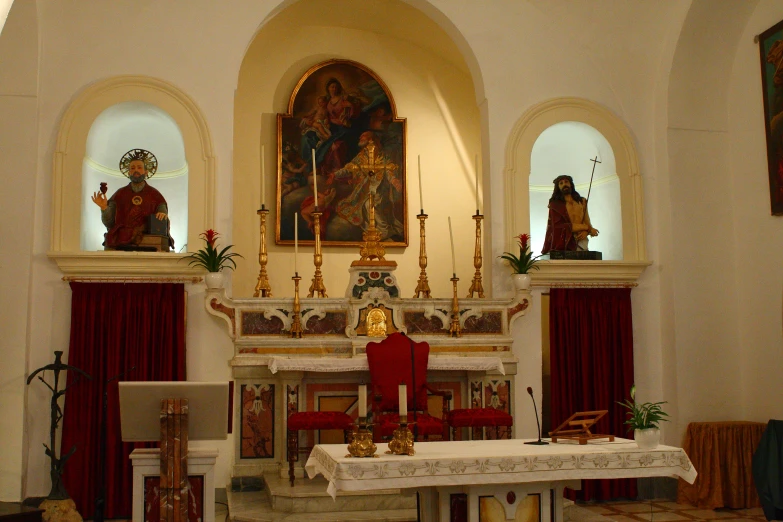 a church with pews and chairs around the altar
