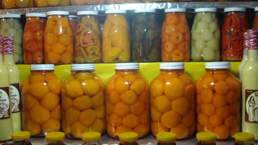 some jars that have some oranges in them