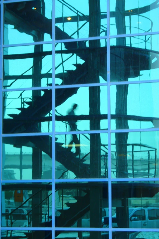 a close up of a spiral staircase reflected in the windows