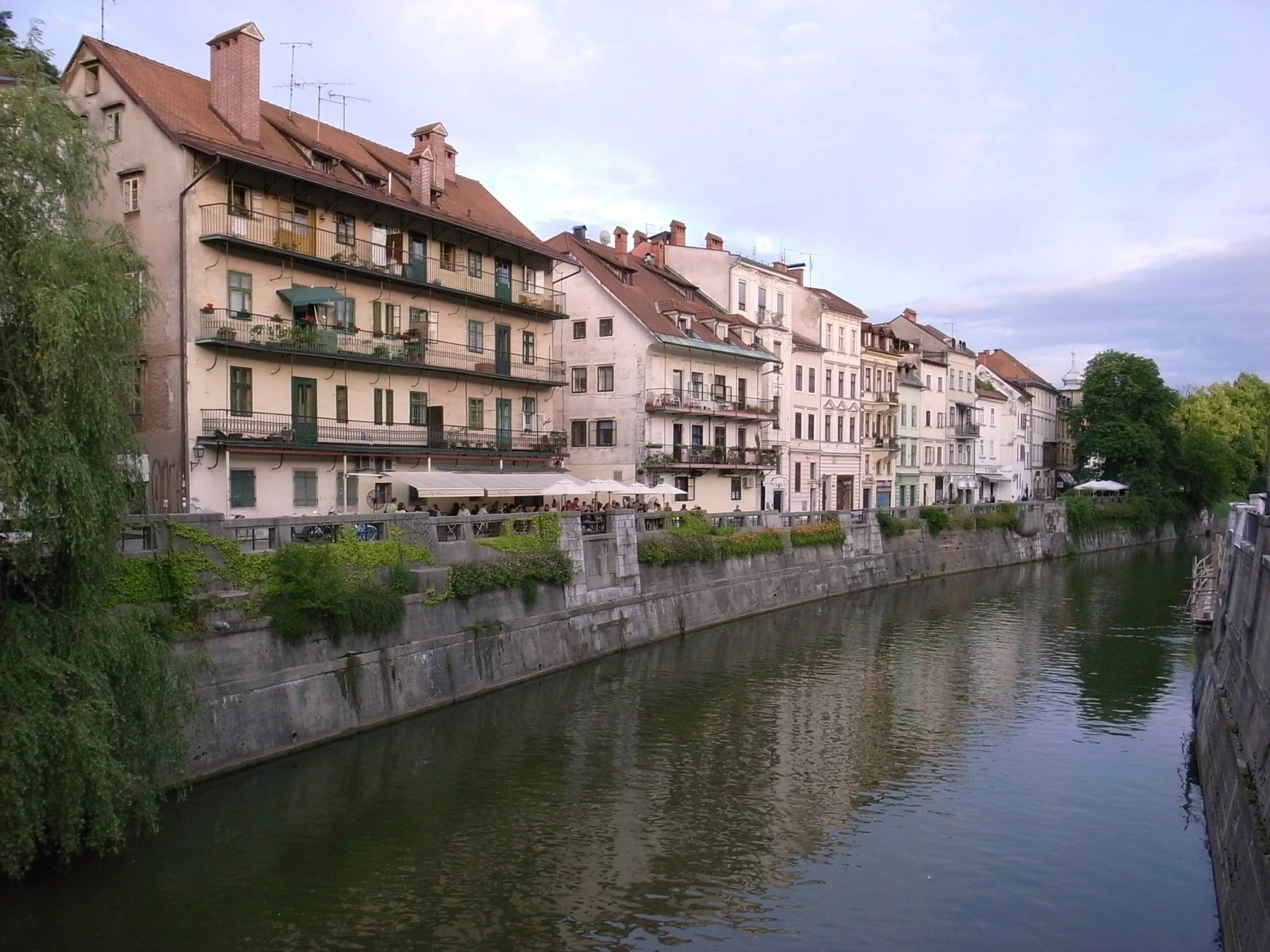 a city street scene with the river in front