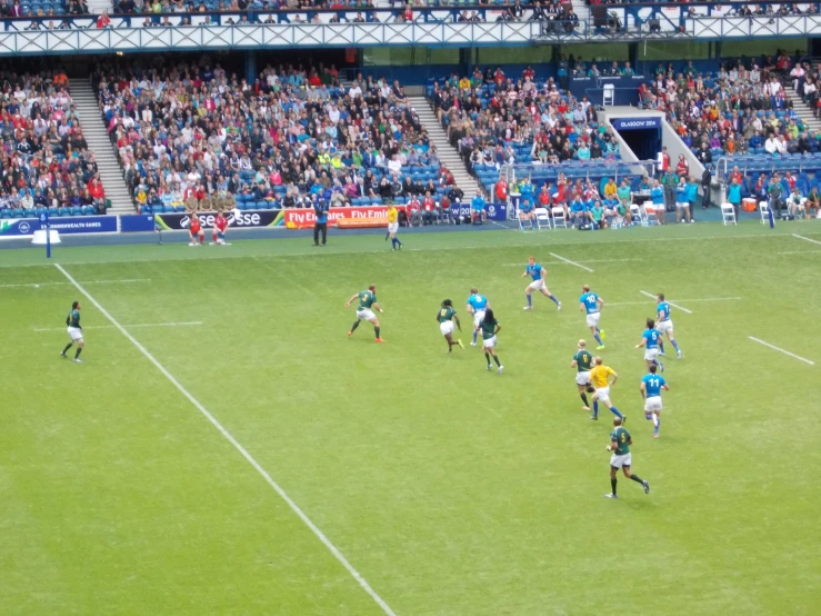 soccer players in a field playing against each other