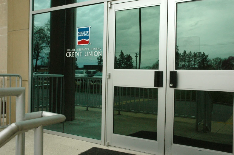 a view of the entrance to a building with metal railing