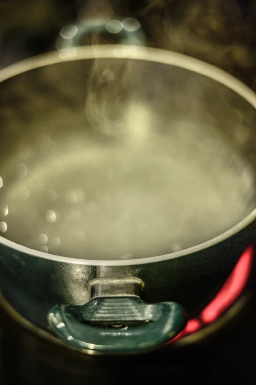 a metal pan on a stove is boiling