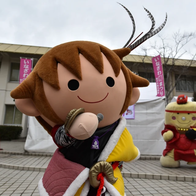 two character floats on the sidewalk near a building