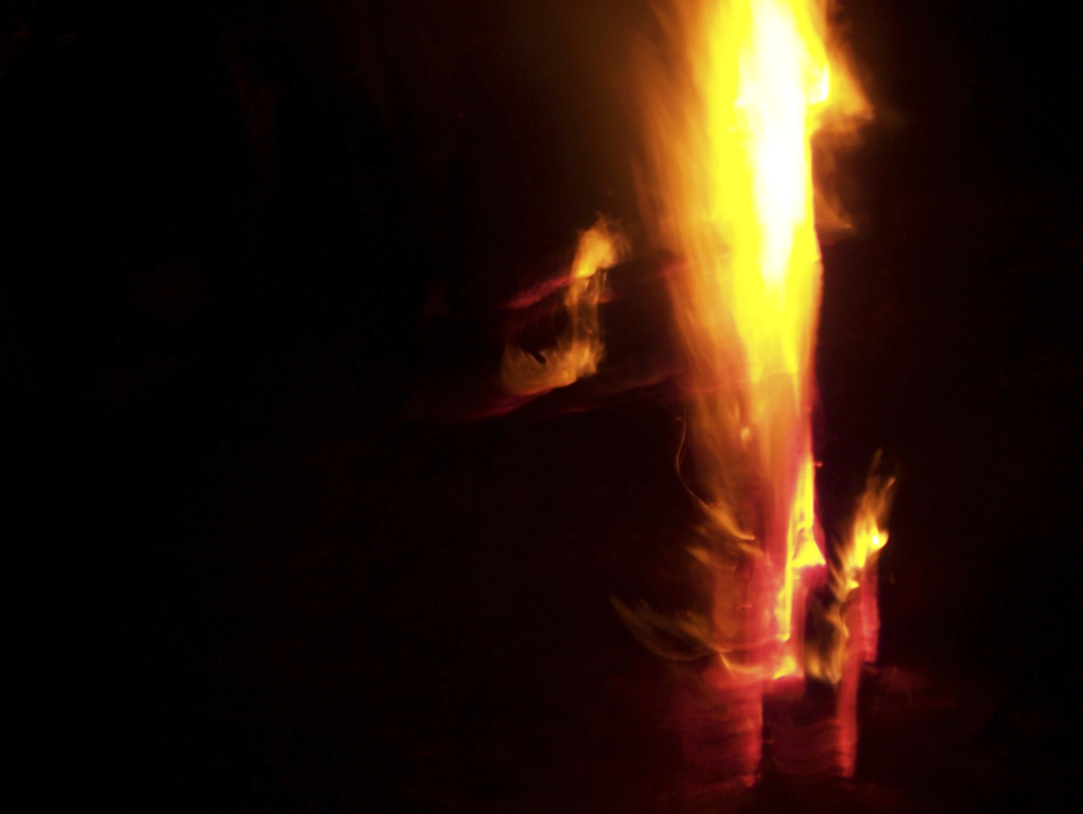 fire is glowing brightly at night on a black background