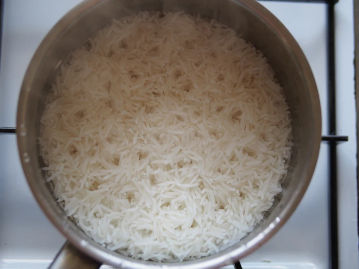 a pot with white rice on top of an electric stove