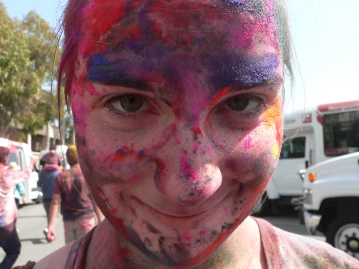 a boy with face paint at the color run