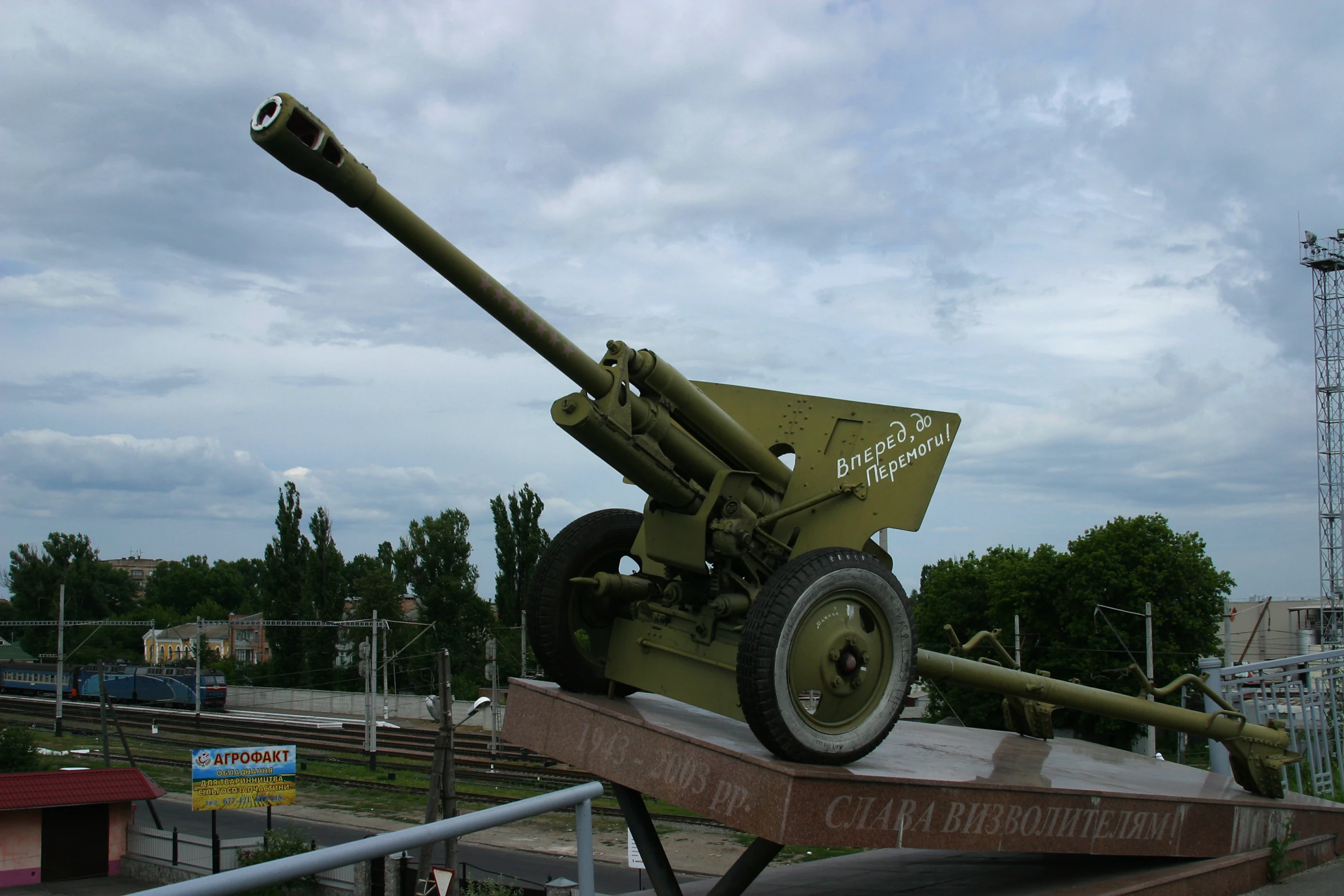 a green antique cannon that is sitting on a wooden platform
