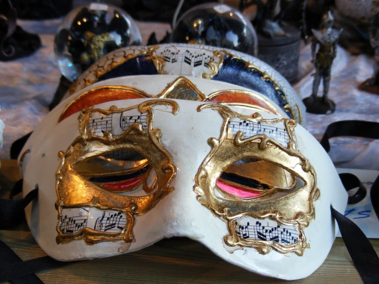 a white mask that has some golden accents