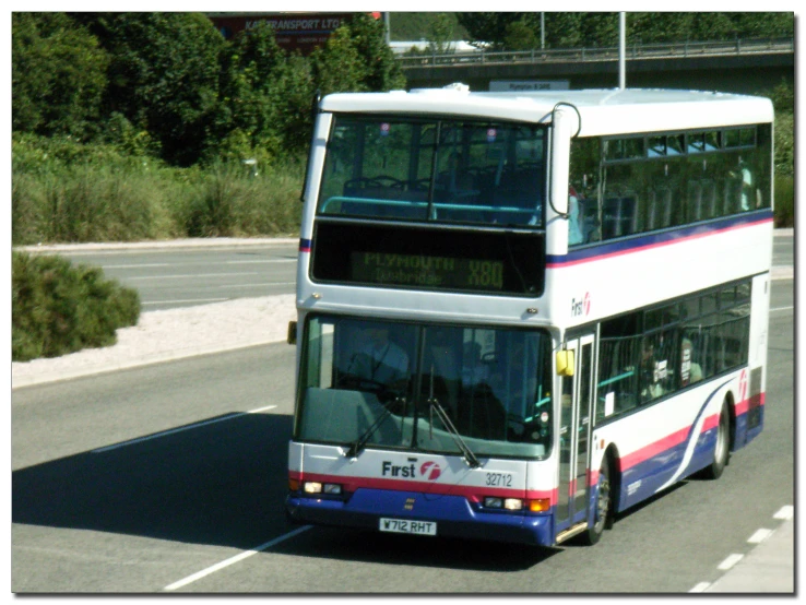 a double decker bus driving down the road