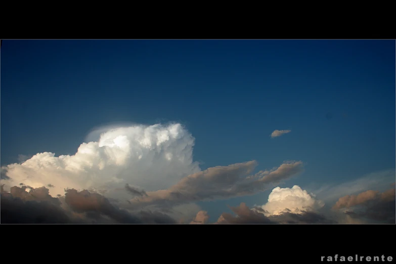 the sky is full of clouds as the airplane flies through