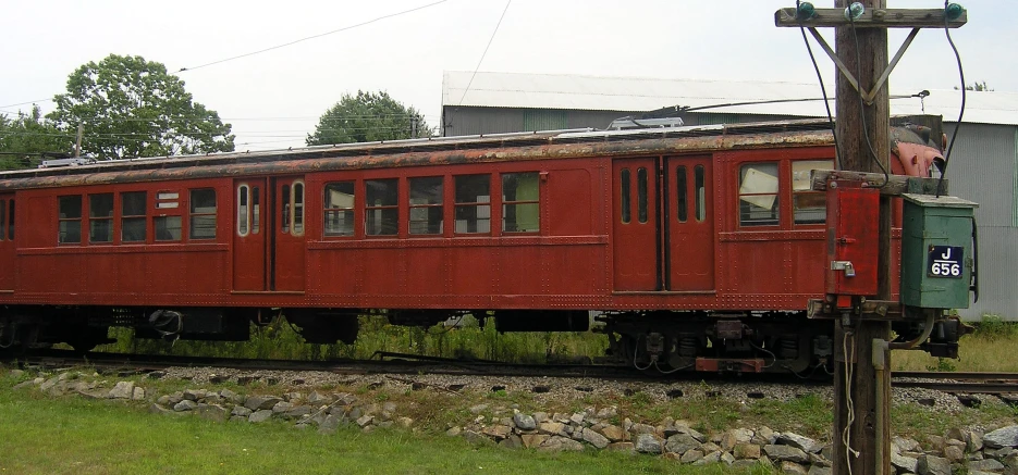 a train car on the tracks in front of an office building