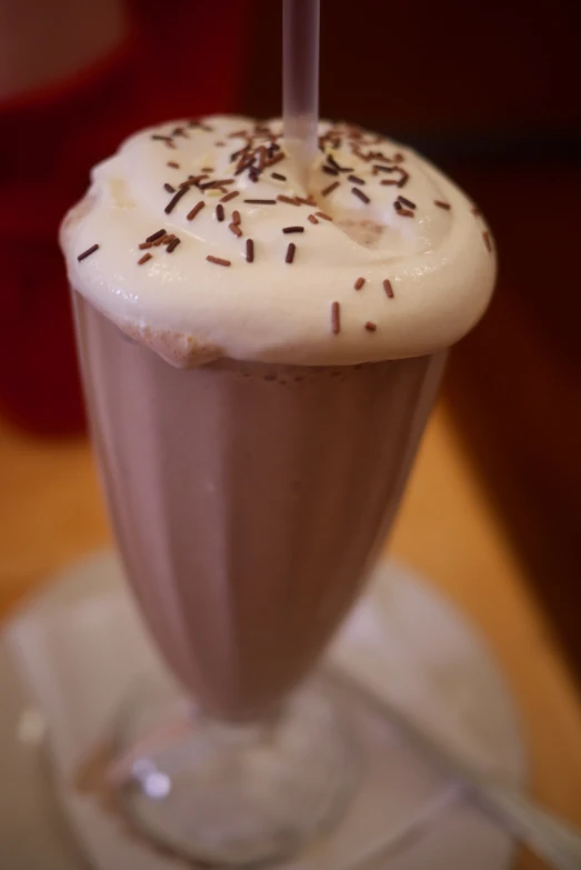 an ice cream milkshake with sprinkles and whipped cream on top