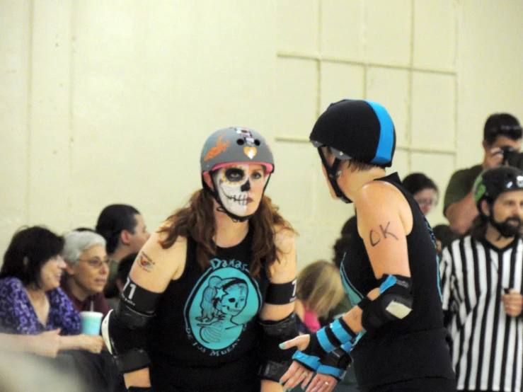 a couple of people wearing skull masks and gloves