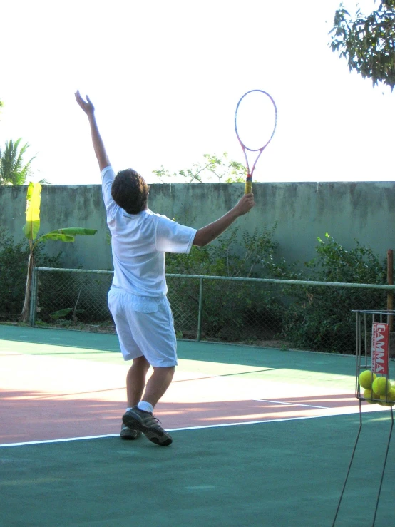 a man getting ready to serve in an indoor tennis match