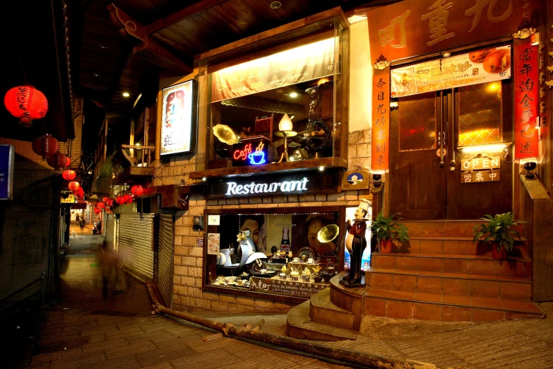 the front of a restaurant is lit up in a dimly lit area