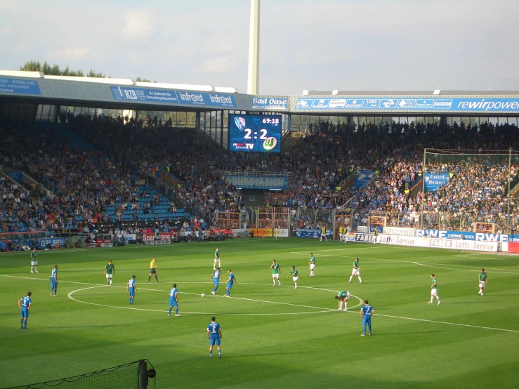 many people are standing around in a soccer field