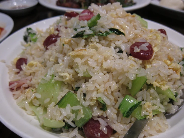 white plate with cooked rice and veggies