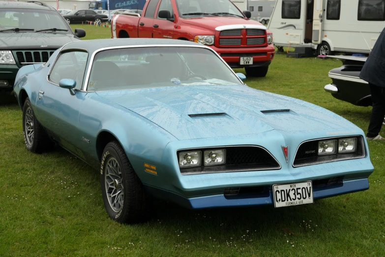 the front of a very nice looking car in some grass