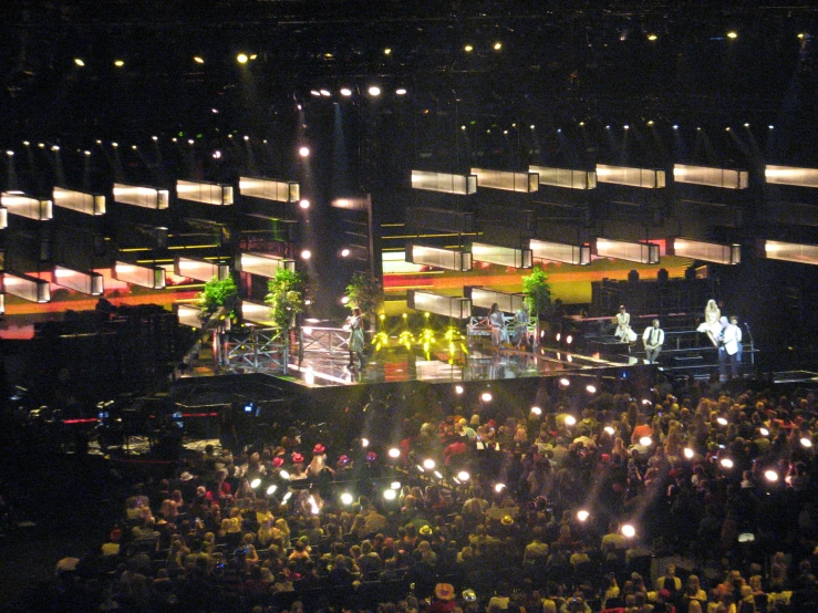 a crowd of people gathered in the dark for a concert