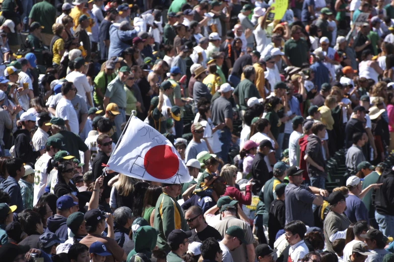 a crowd of people with flags and hats