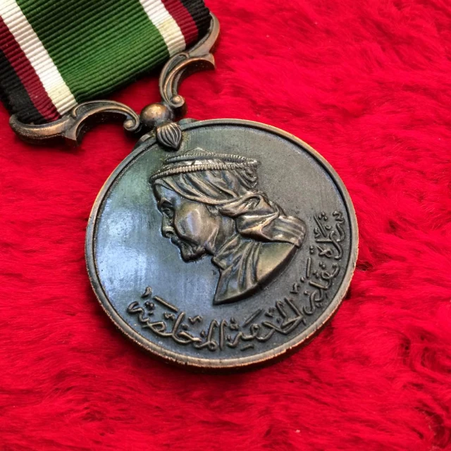 a medal is on display against a red blanket