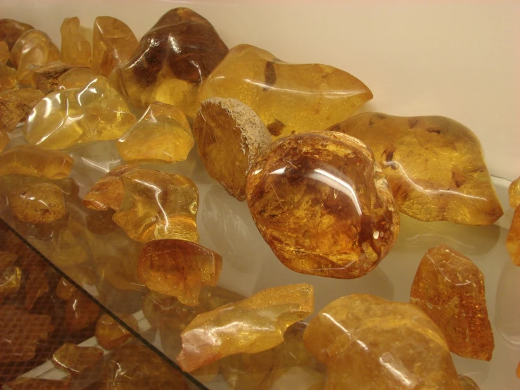 large collection of yellow and orange crystal rocks in a display case