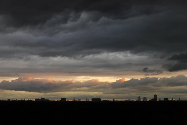 the sky has been cloudy and black, as a boat is on the ocean