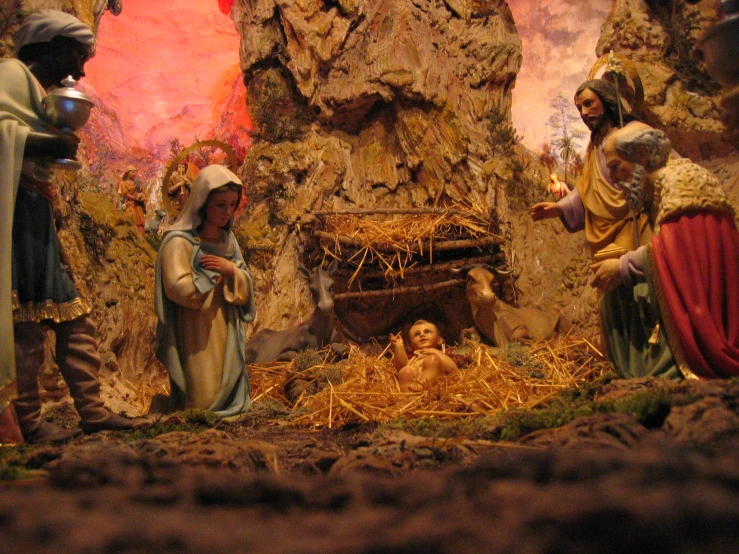 nativity scene with figurines of baby jesus in manger scene
