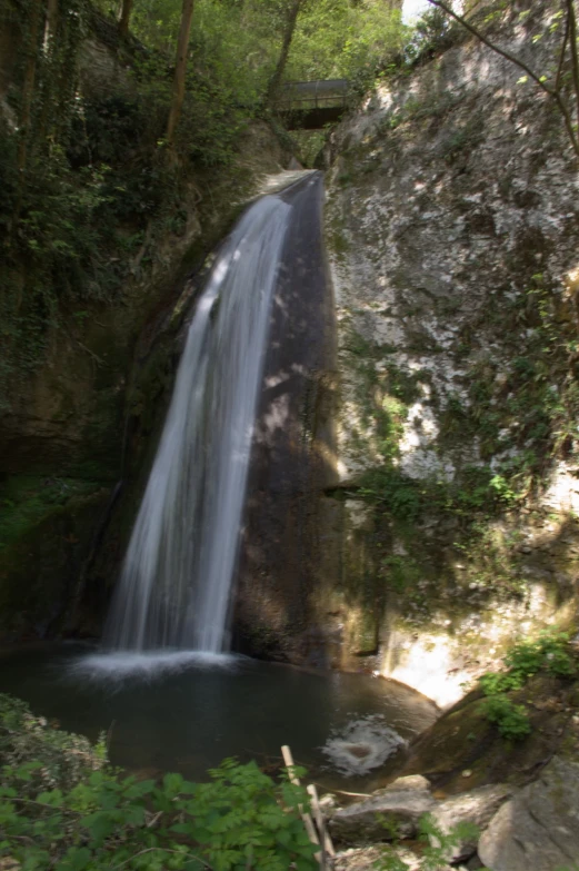 a beautiful waterfall flowing down to the woods