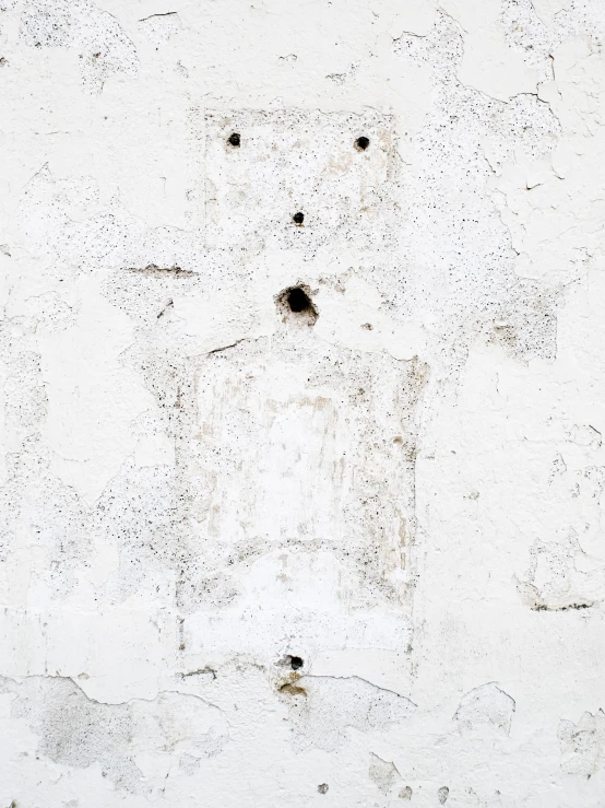 the cement on the wall shows holes in the cement