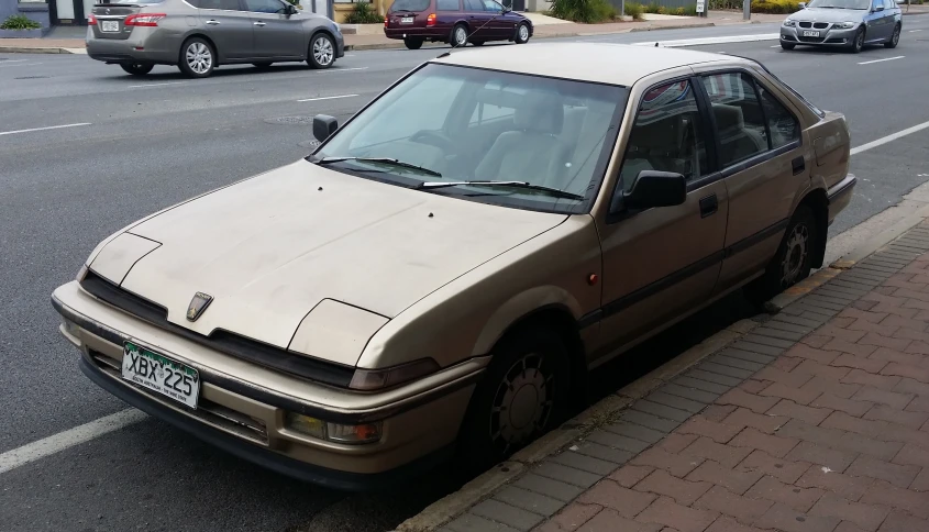 a car is parked on the sidewalk next to the curb