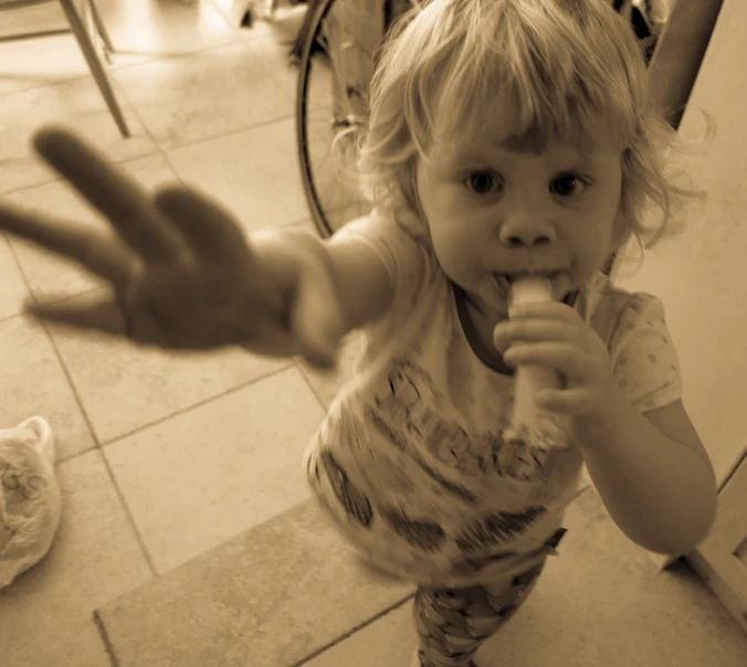 a young child is reaching out with her hands